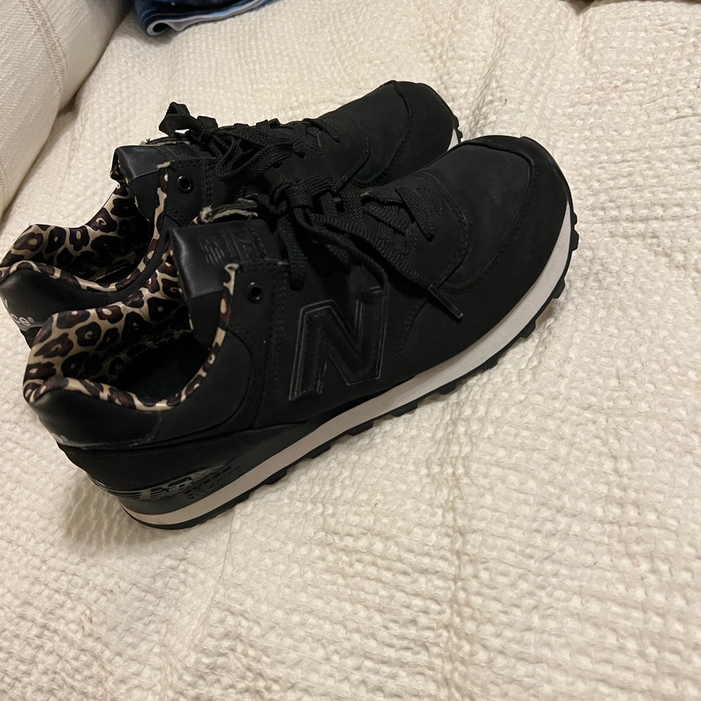 New balance tennis shoes. Black w/cheetah on inside. Worn once. Size 8.5